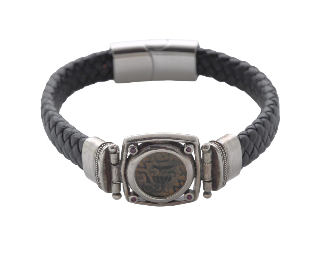 Bracelet with black braided strap and silver clasp on a white background